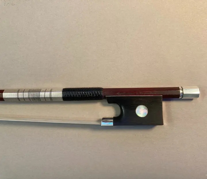 Violin bow with a sterling silver and black silk thread wrapping and a lizard skin grip
