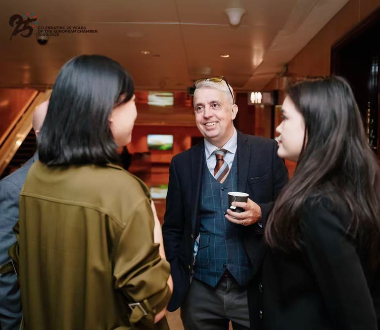 Professional networking event featuring business colleagues in conversation at a European Chamber event.
