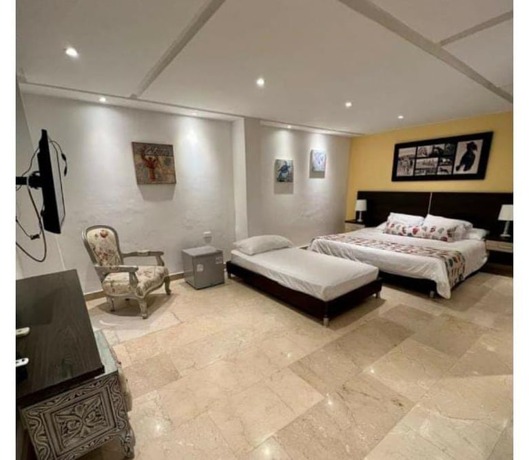 a bedroom with a bed and a couch