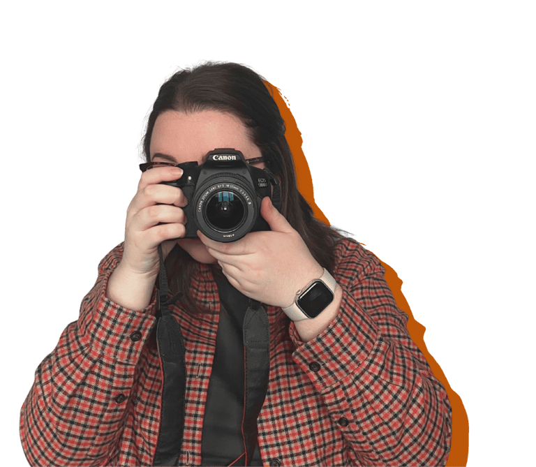 A women (Erin, owner of EB Socials) pointing a canon camera at the camera