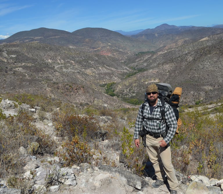 a man with a backpack on a mountain