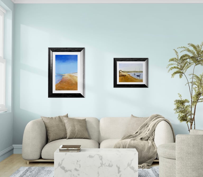Modern living room featuring coastal wall art above a beige sofa and marble coffee table.
