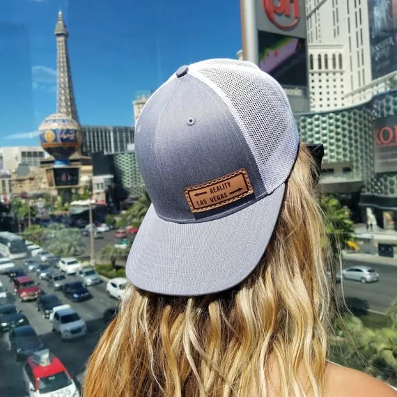 a woman wearing a hat and a leather patch