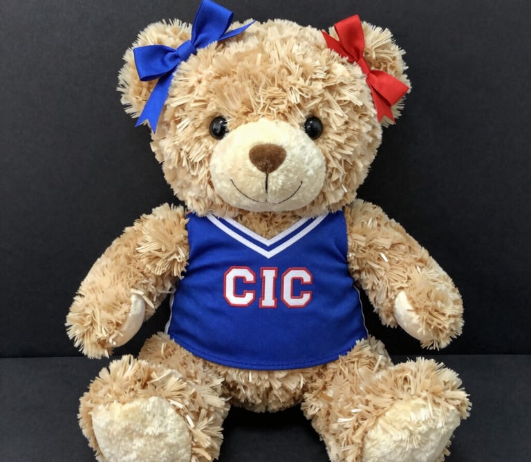 A variety of personalized water bottles and gear laid out on a sports field.