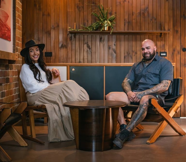 Rebecca and Michael sitting in chairs in a room