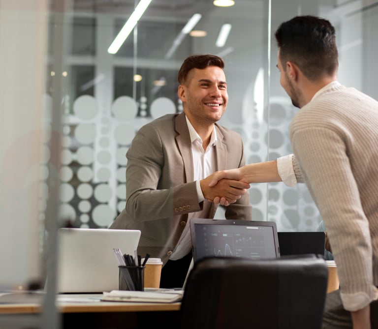 a man shaking hands with another man in a suit