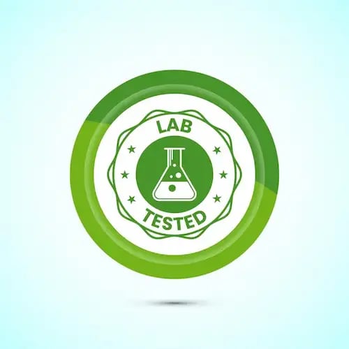 Green lab tested circular seal icon with a laboratory beaker for quality assurance certification.