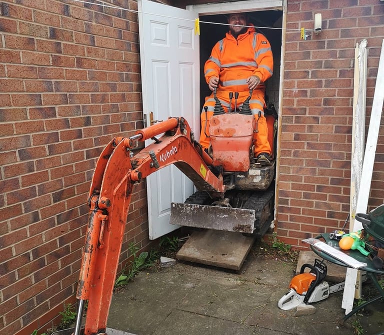 Digger operator preparing foundation work for construction in the West Midlands