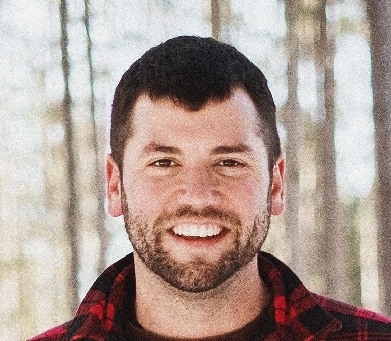 A man smiling outdoors