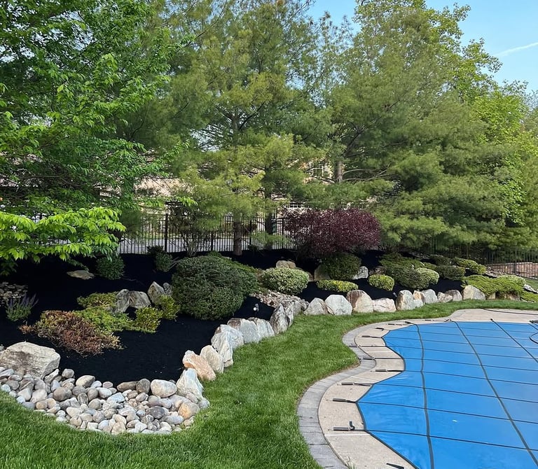 excellent landscaping and hardscaping of grass, stones and trees by NP Landscaping