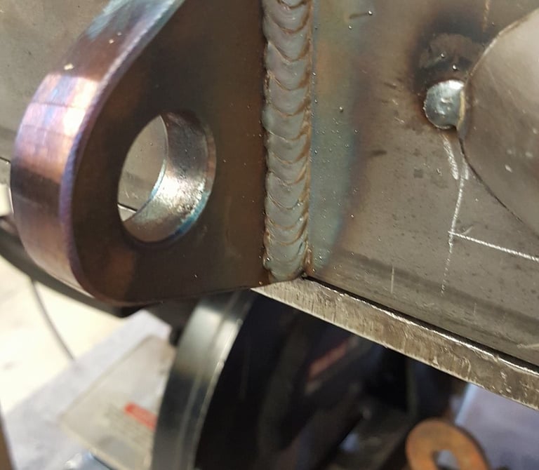 MIG welding a recovery tab on a custom bumper. Welding Okotoks, custom fabrication.