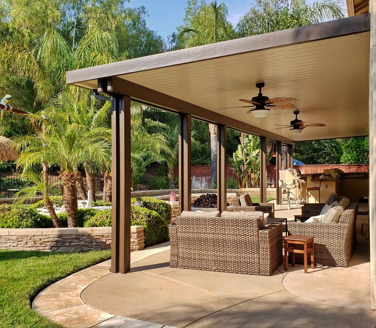 Newport style solid Alumawood patio cover with palm trees.