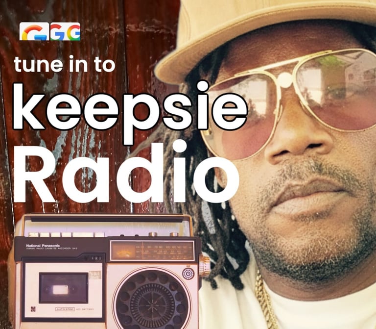 A man in sunglasses and a baseball cap next to a vintage radio for Keepsie Radio station.