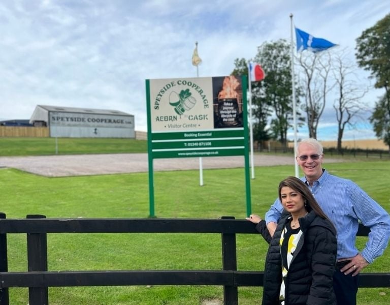 a man and woman standing in front of a sign