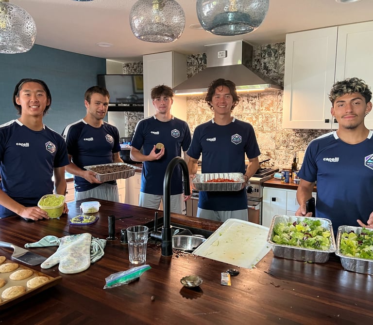 Midlakes soccer players showing off the meal they have prepared for The Sophia Way.