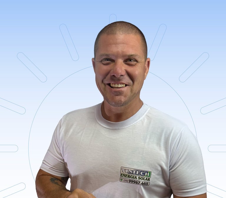 Proprietário da empresa mexendo no celular e de camisa branca com a logo da Vintech no peito.