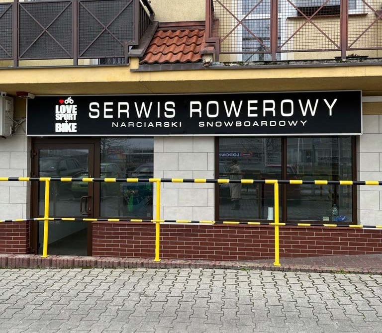 a service bike and snowboard skis center with a sign that says service overcrowing