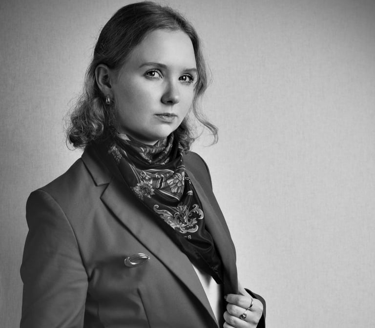 a woman in a suit and scarf with a scarf around her neck