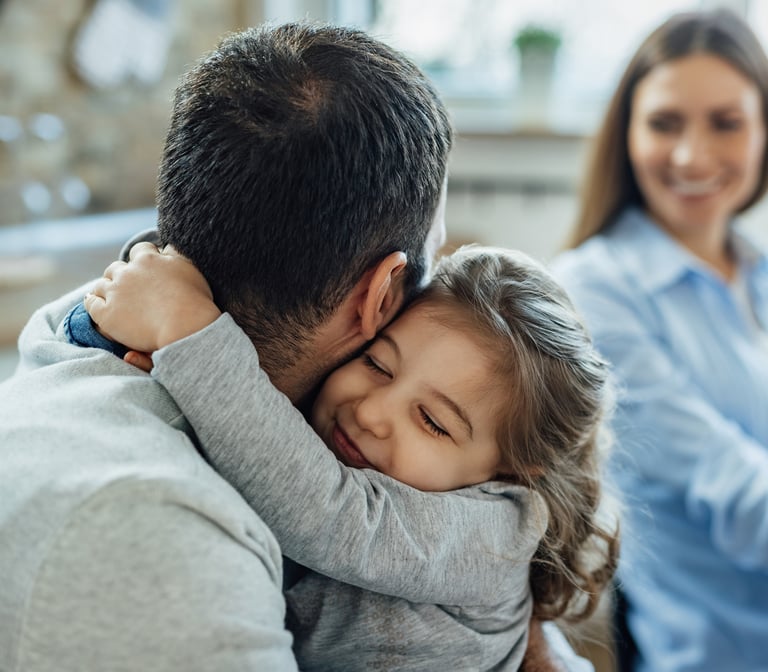 a man and a little girl are sitting on a couch
