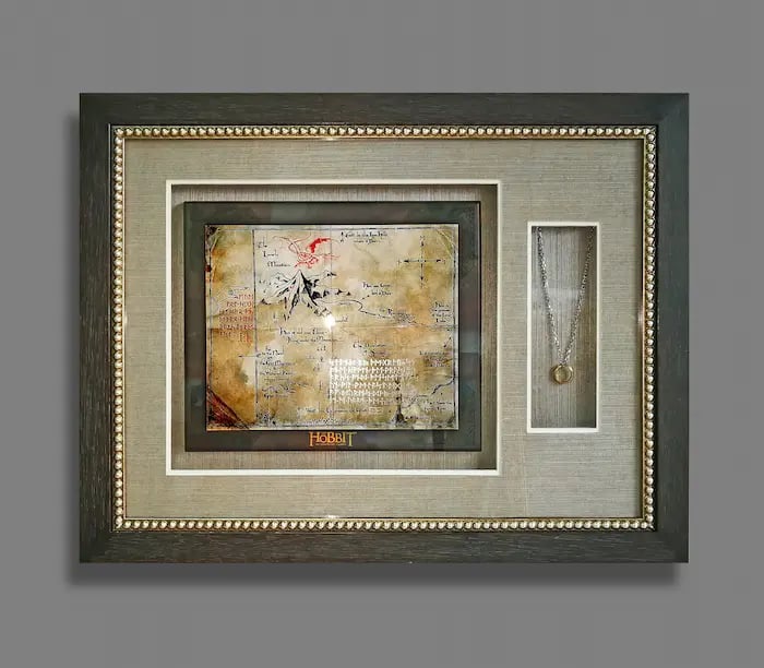A shadow box frame encasing LoTR limited edition collectables