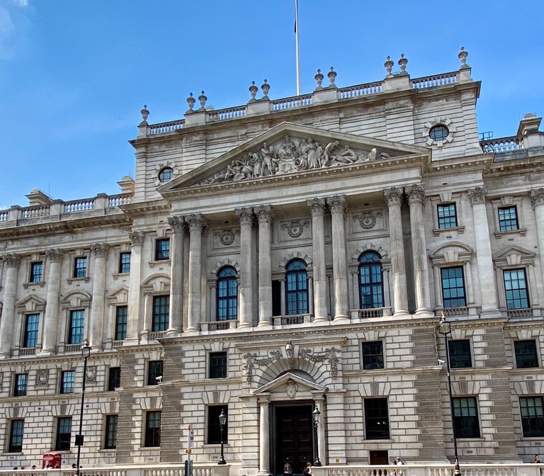 a large portland stone building with traditional windows and beautiful carved stone figurines 