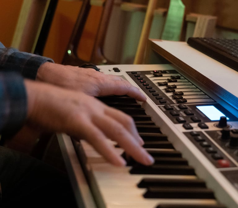 Luke Stidworthy playing keyboard at Vox Music Recording Studio in South Manchester
