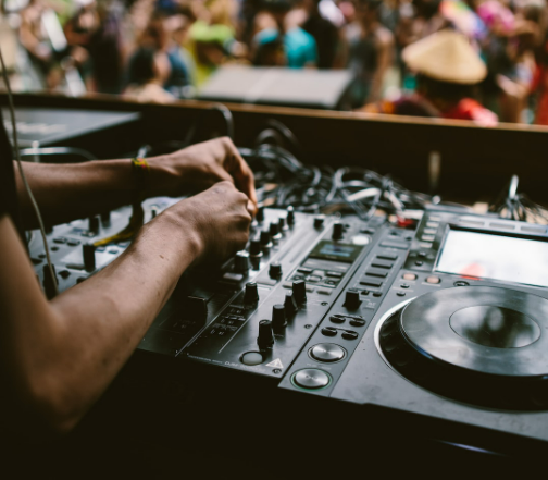 a dj mixing up a music event using a djm mixer