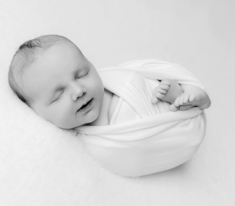 a baby is sleeping in a blanket wrapped in a blanket