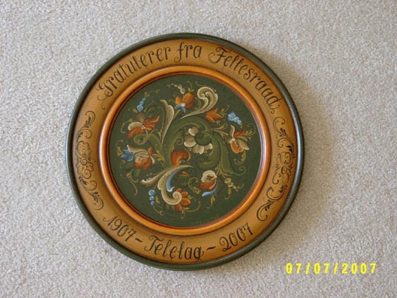 A green and gold rosemaled plate