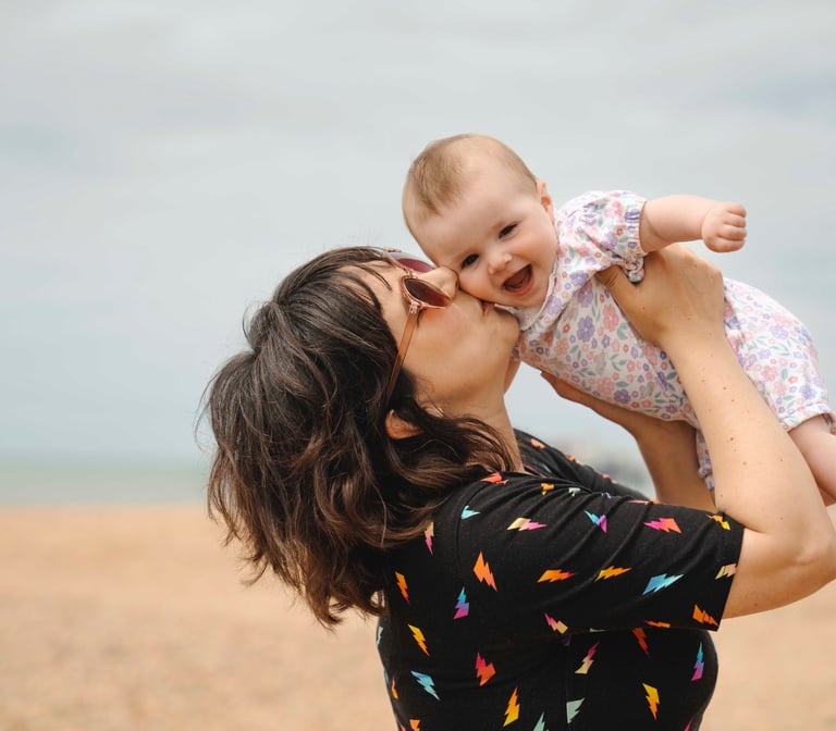 mother kissing her baby 