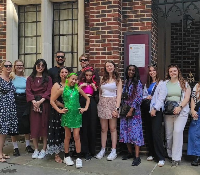 a group of people standing in front of a King's Chapel of Savoy