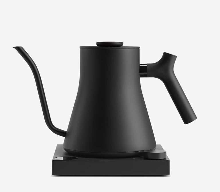 FELLOW electric gooseneck kettle with precision pour spout on a matching minimalist heating base.