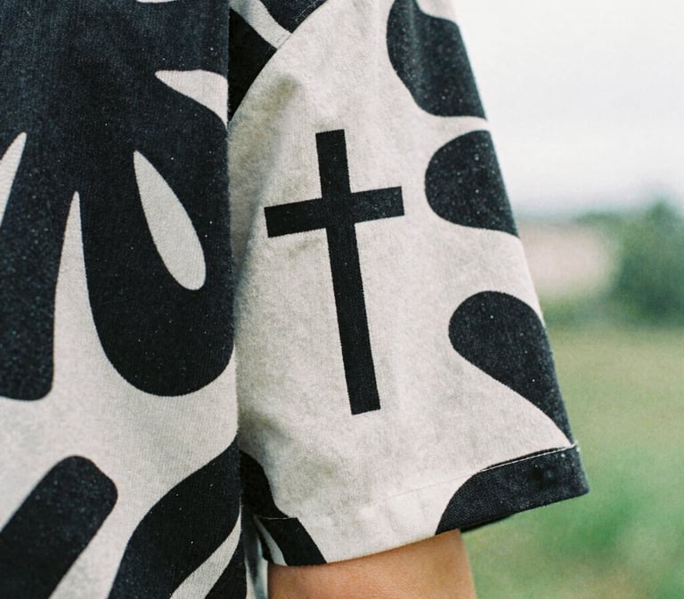 Close-up of a bold organic graphic print on a heavy cotton sleeve, overcast natural daylight, high-contrast details, 35mm film