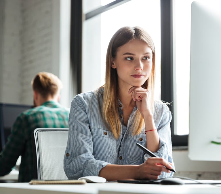 a woman sitting at a desk with a pen and a pen