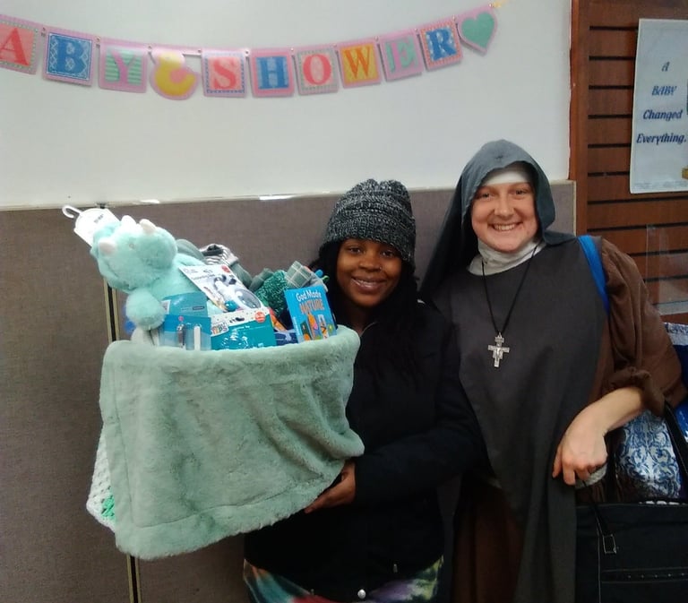 Baby boy is due soon! Mom gets a dinosaur baby basket at the Rose Garden Mission