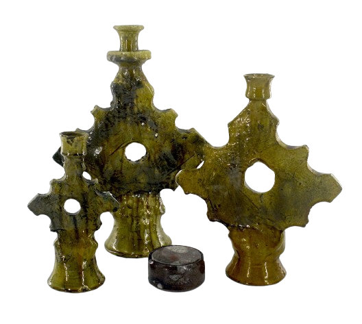 a group of three vases with a candle holder