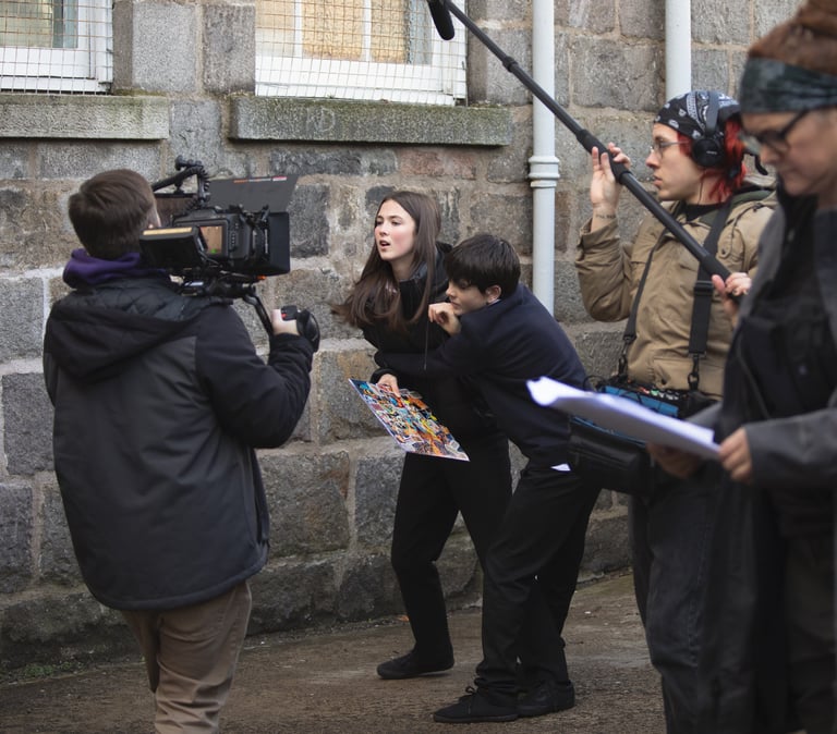 Commercials production companies: a woman filming with a camera and a second camera