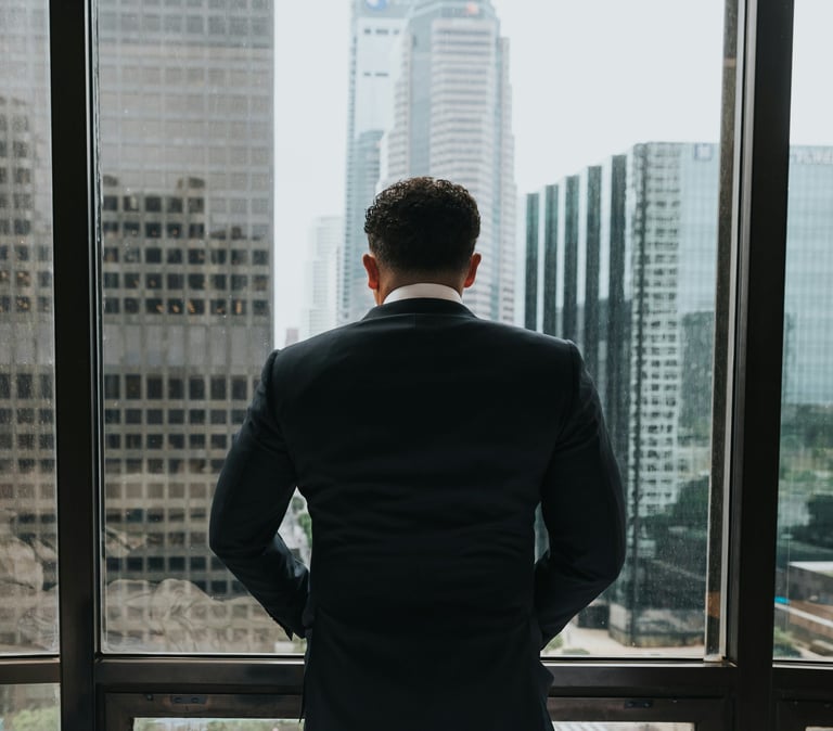 Frustrated business leader overlooking skyscrapers, symbolizing ERP software selection challenges