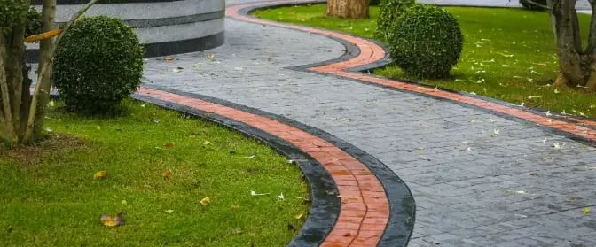 a red and clack concrete walkway