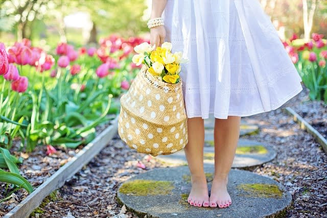 girl holding a basket of flowers