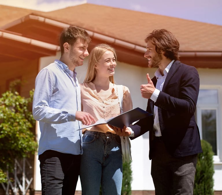 a man and woman standing in front of a house