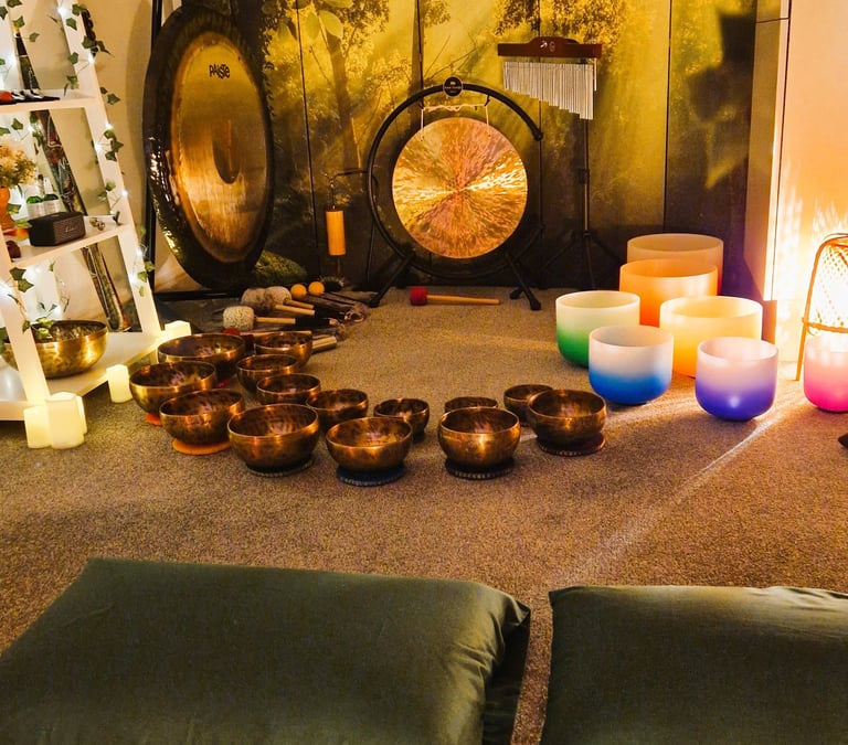 Studio with gongs and singing bowls on the floor in front of two pillows