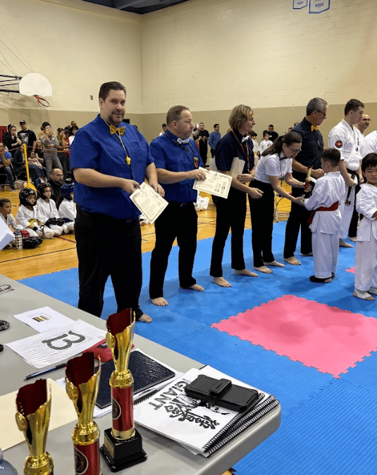 a man in a blue shirt is holding a certificate