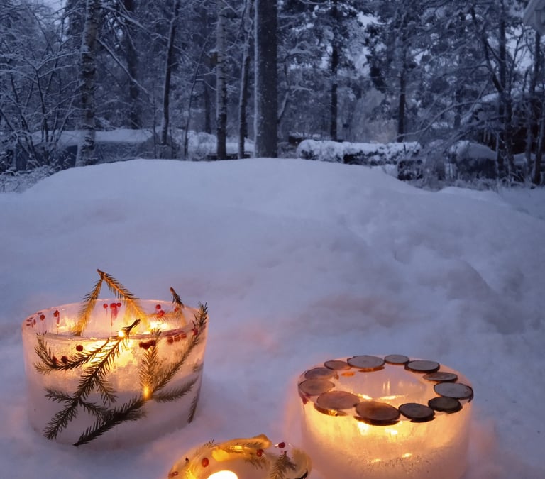 Ice lanterns glowing in the snow-covered forest at Nature Dream Days