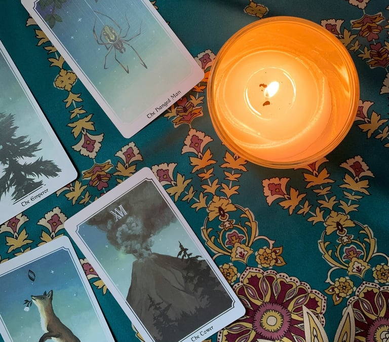 Tarot cards and blue table cloth. Photo by Airis Noyer at Unsplash.