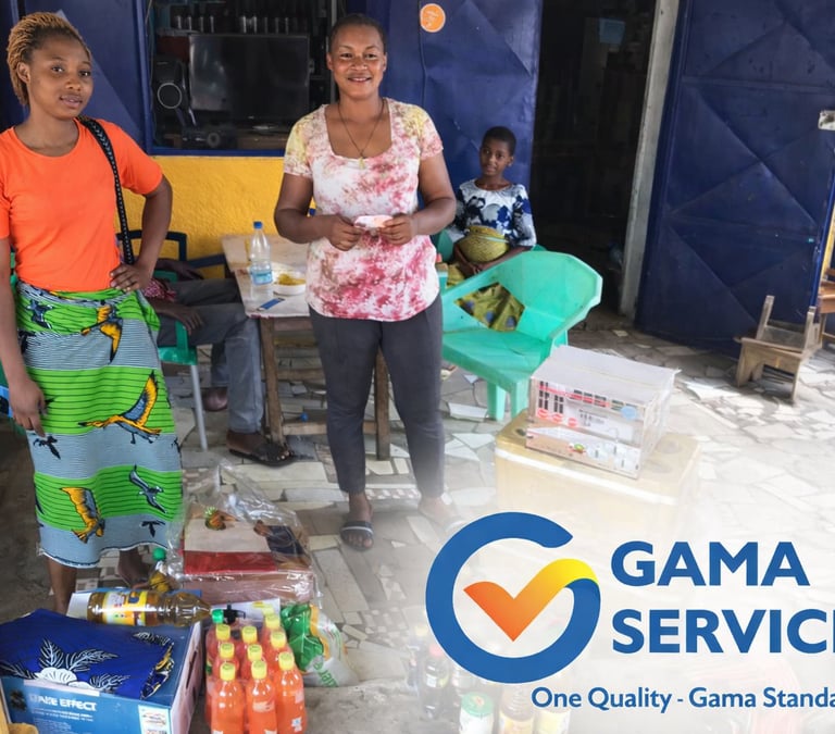 African women smiling outside a local storefront with groceries and Gama Service branding.