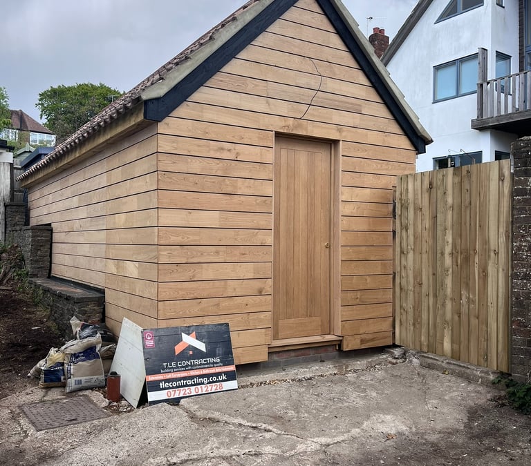 Brighton garage conversion with sweet chestnut timber cladding and insulated pitched roof