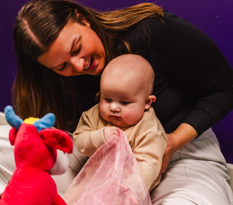 Mum looking over and smiling at her baby in Moo Music Worksop.