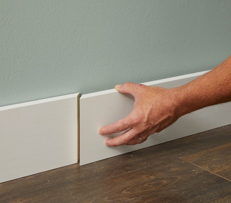 Baseboard trim covering the edge gap between wall and flooring.