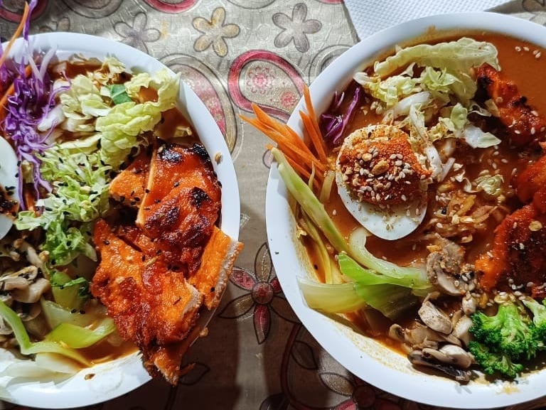 Street-style ramen bowl with creamy chicken and a spicy miso broth, offering a satisfying and flavor
